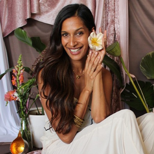A woman holding a silk flower.